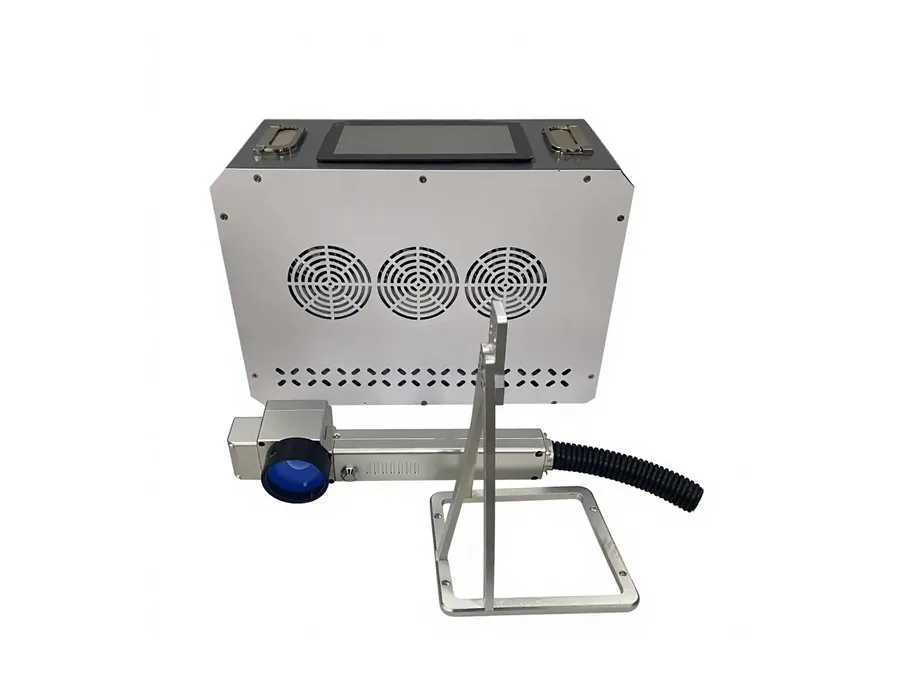 Handheld pulsed laser cleaning head removing surface contamination from metal